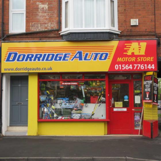 Dorridge Auto shop front with bright yellow signage with Dorridge Auto in blue font and A1 Motor Store in yellow on a red background to the side