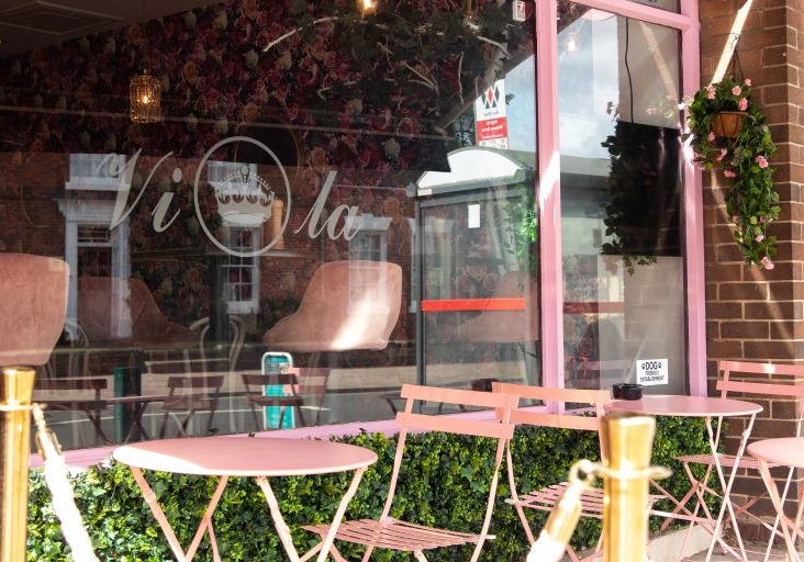 Outside seating with pink tables and chairs at Viola